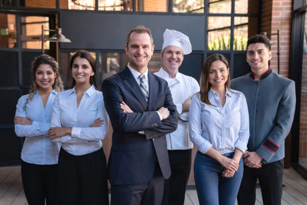 Hotel and restaurant team including a manager, chef and front-of-house staff